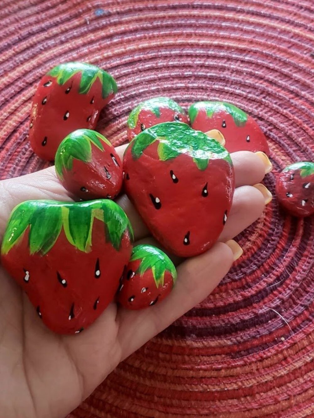 Strawberry hand painted rocks.